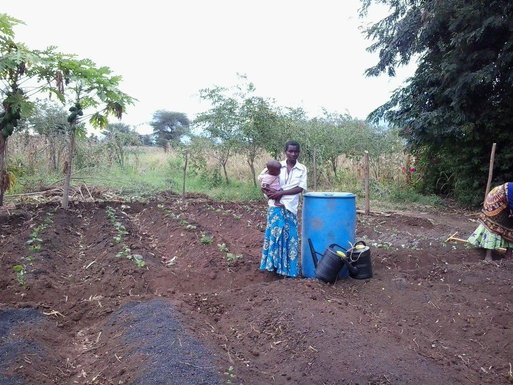 Genis Michael in front of the planted garden