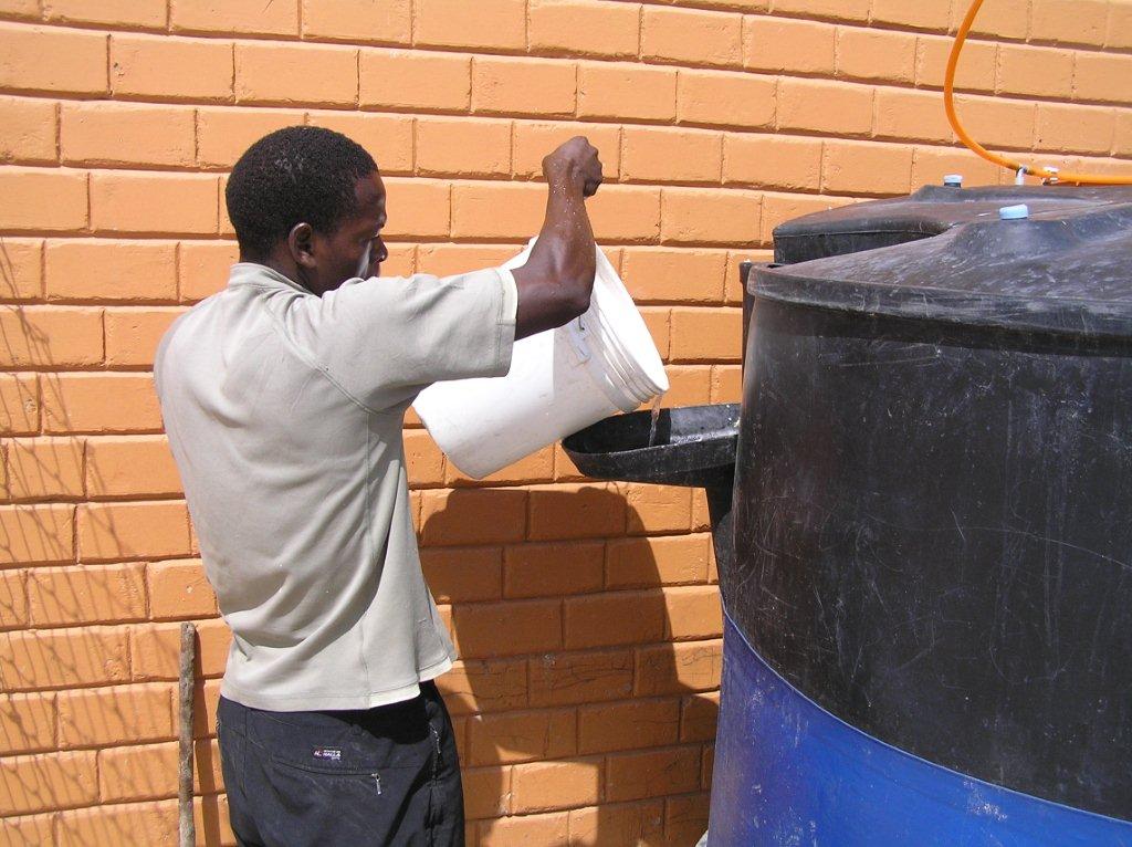 Putting kitchen scraps into the bio-digester