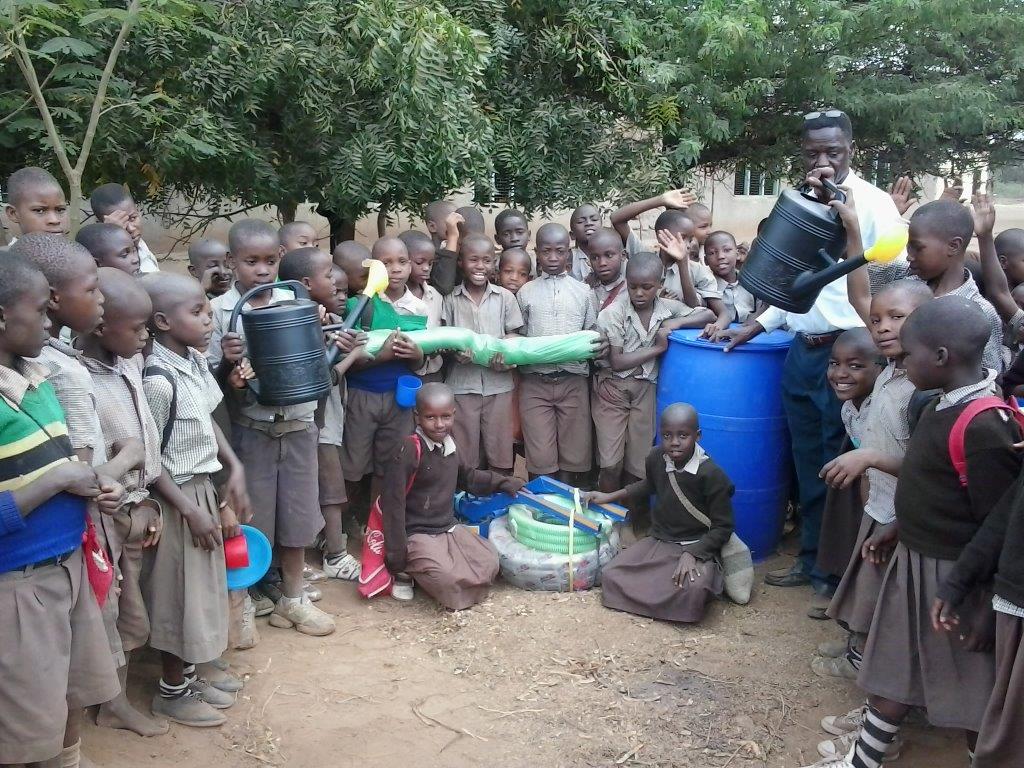 Students and teachers with their new money maker water pump