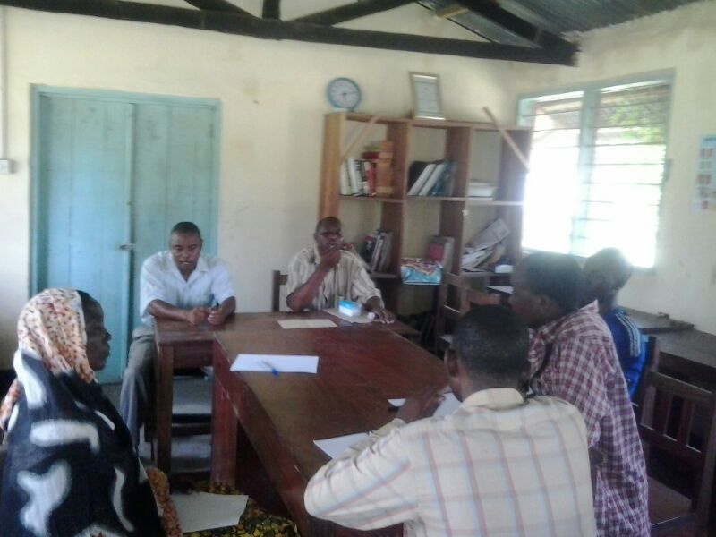 Mr. Juma, second from left, discussing the cow projects with the Mtumbis and Kikundi cha Mama.