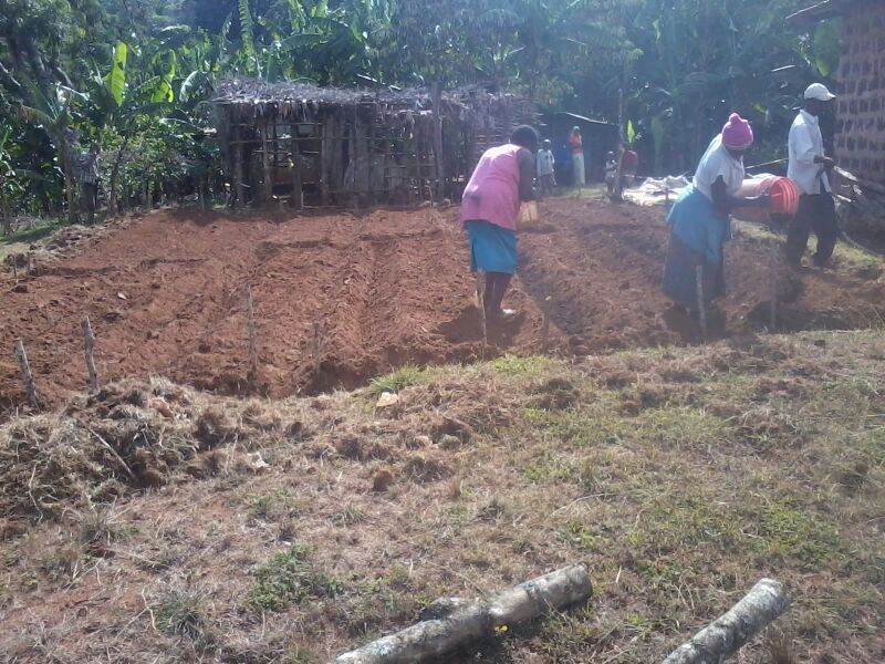 LKN family adding compost to their new garden.