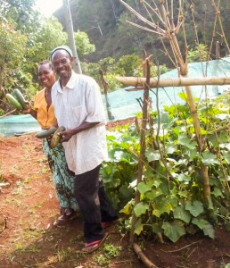 Mama and Baba BMM smiling over a good harvest of zucchini and cucumbers._edited