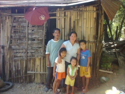 Family in front of light bamboo house