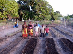 Asha and her family after her newly planted garden