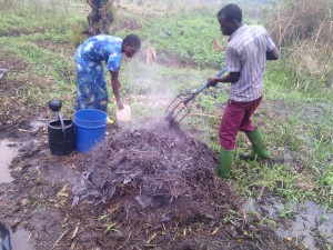 Teopista, right, and Sheffa flipping compost. The steam coming out of the compost means decomposition is happening. The heat generated by decomposition helps kills bad bacteria. After the first few weeks the piles won't produce heat.