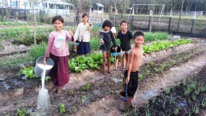 CWC's children helping with the organic vegetable garden